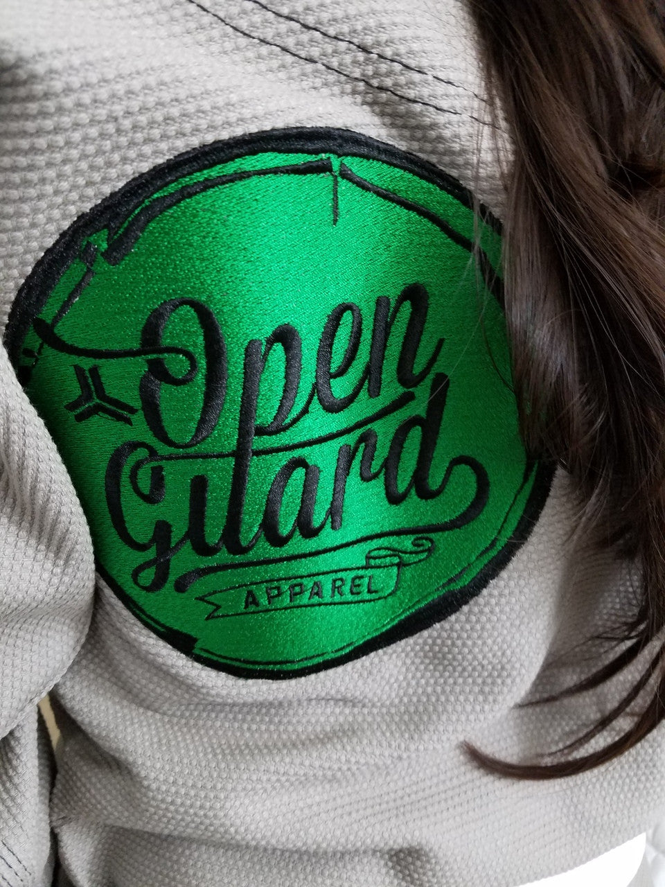 Close up of the Open Guard Apparel embroidered patch on the back of the gi.