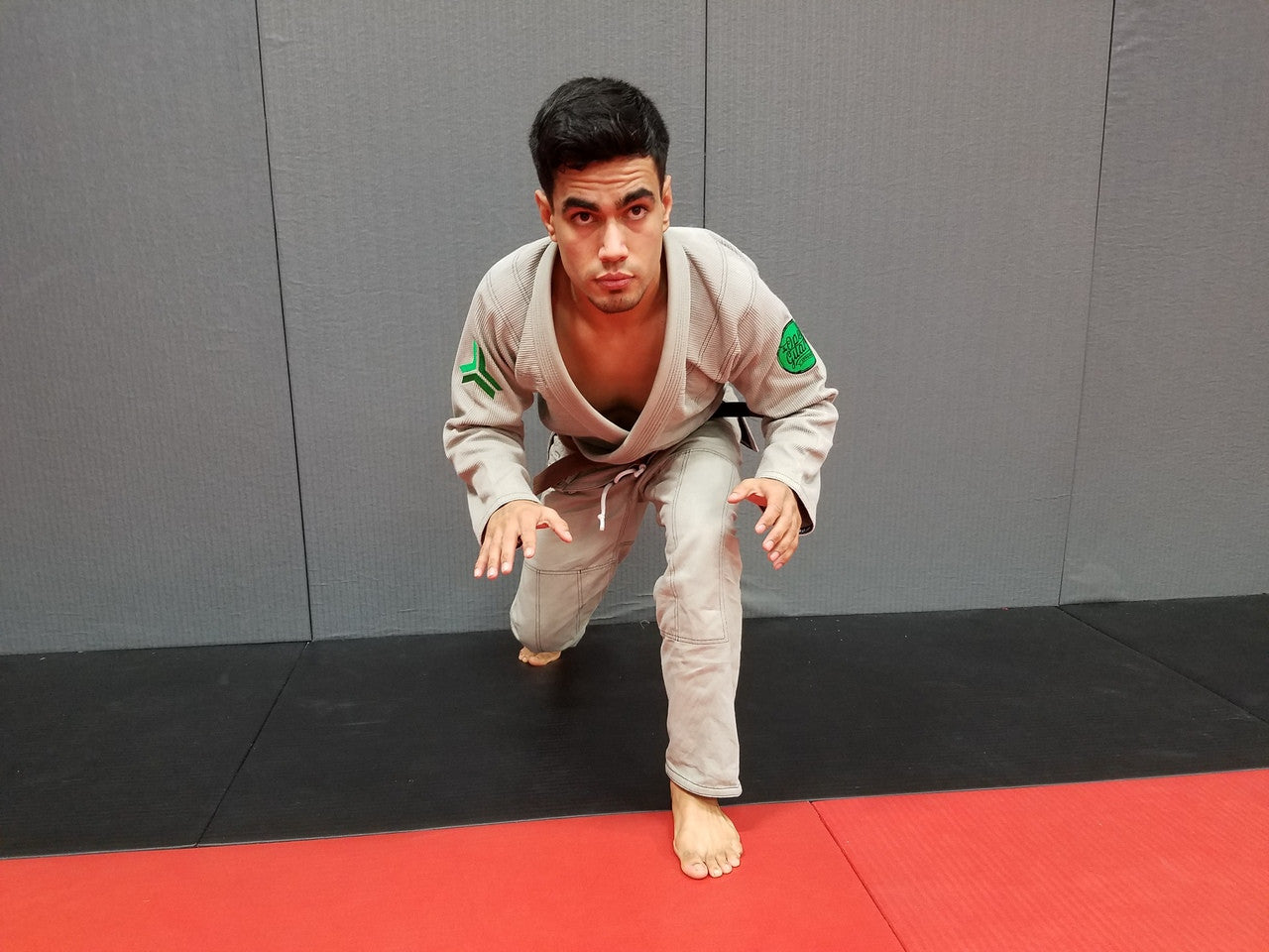 Front view of the Open Guard Apparel Circle Flow Gi in Tactical Sand & Emerald.