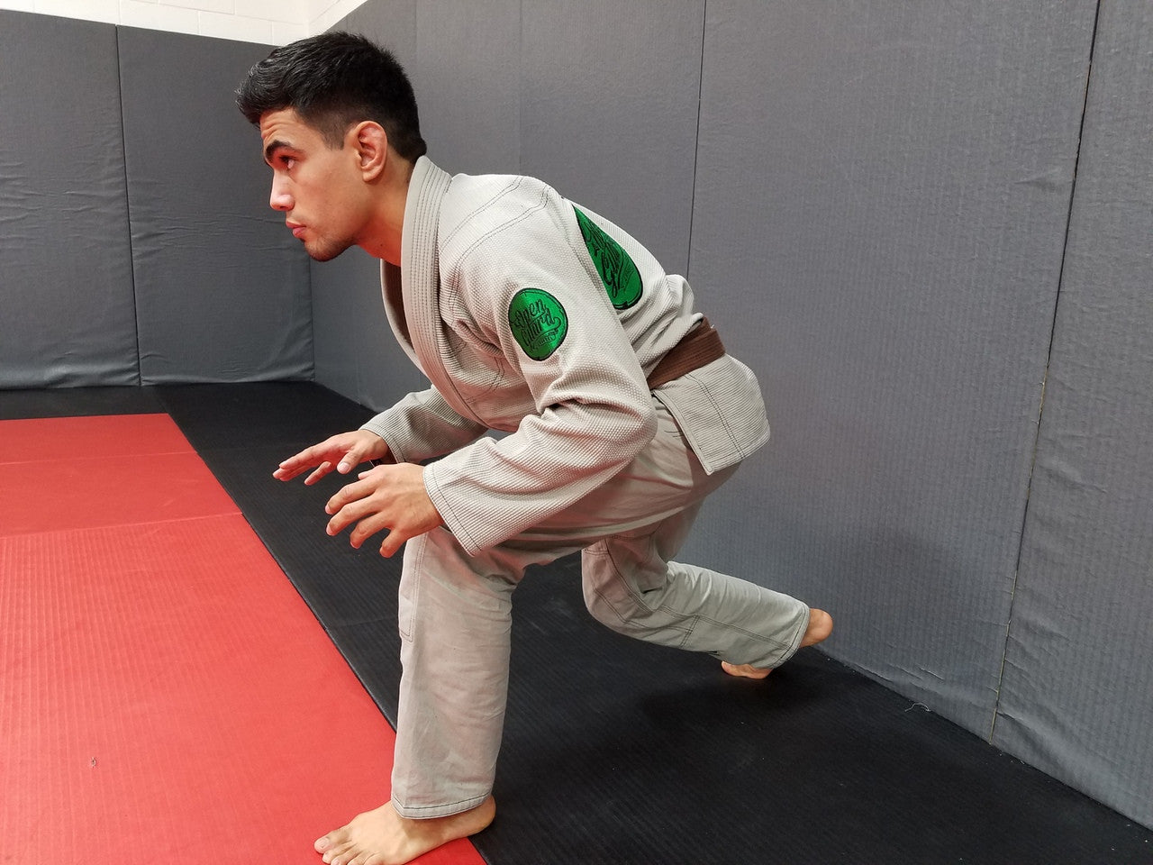 Side view of the Open Guard Apparel Circle Flow Gi in Tactical Sand & Emerald.