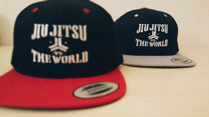 OGA Open Guard Apparel Jiu Jitsu vs The World Snapback hat.  Grey black hat with white embroidery.  Jiu Jitsu vs the world series from Open guard apparel. 