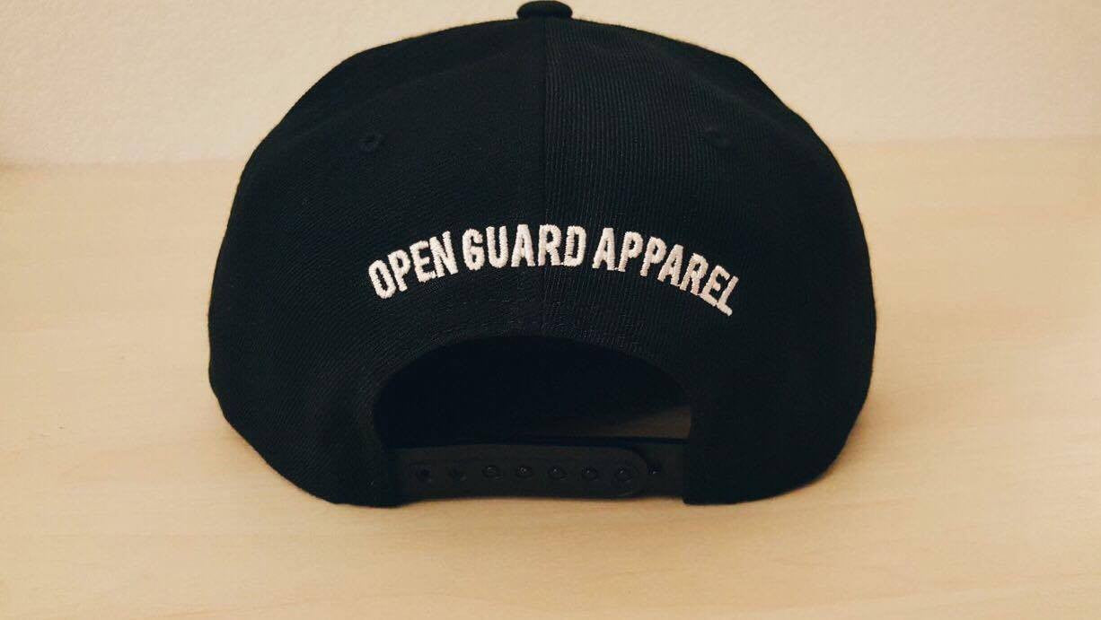 OGA Open Guard Apparel Jiu Jitsu vs The World Snapback hat.  Black hat with white embroidery.  Jiu Jitsu vs the world series from Open guard apparel. 