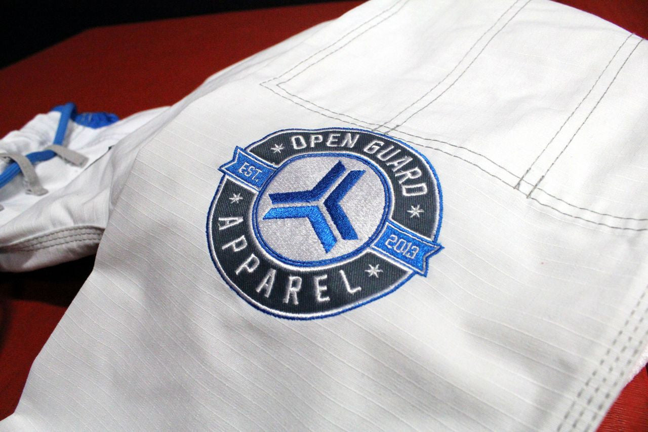 Open Guard Apparel White Blizzard Gi now available in www.openguardapparel.com  Teal accents across the gi ready for the mats. 