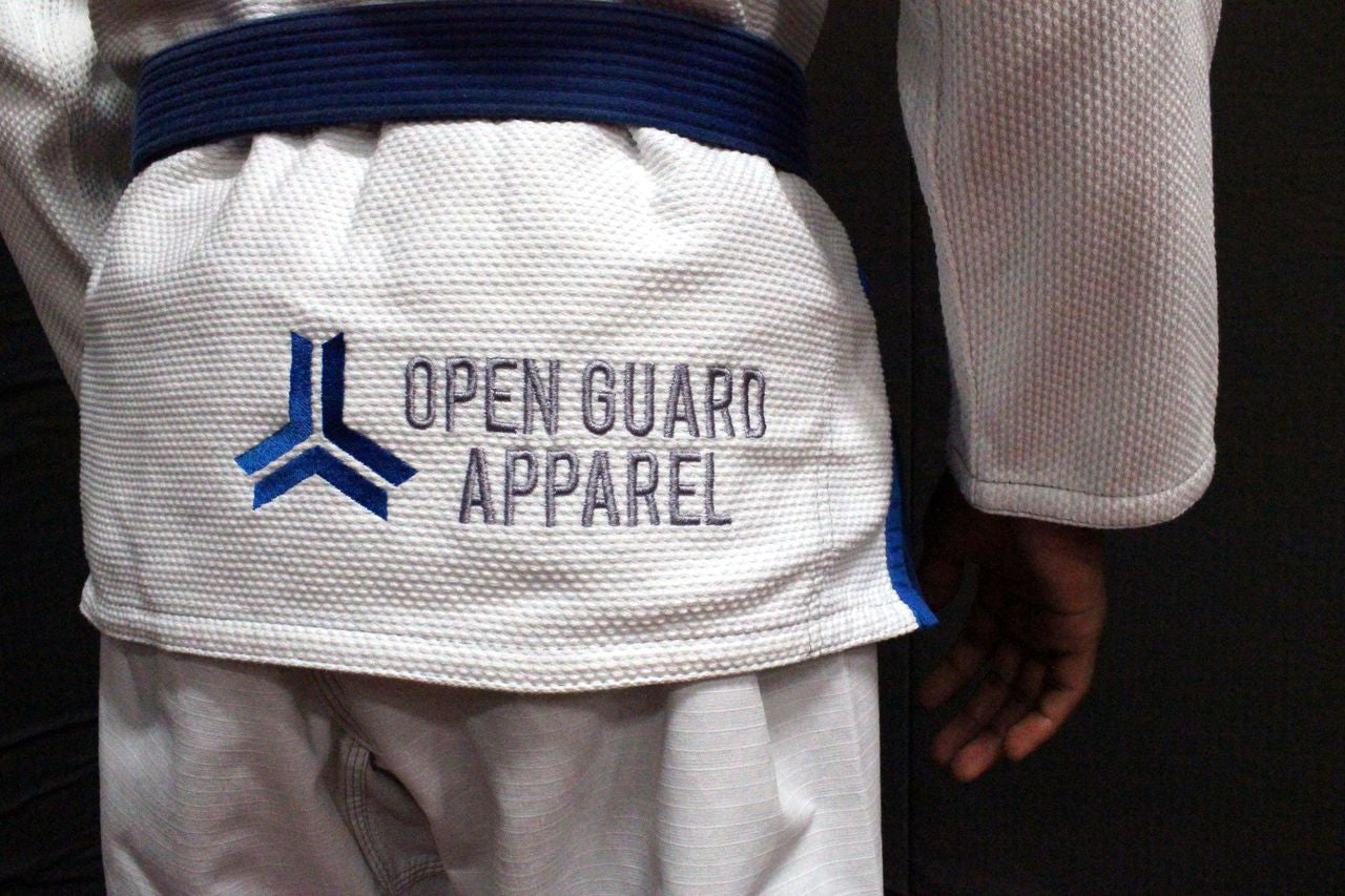 Open Guard Apparel White Blizzard Gi now available in www.openguardapparel.com  Teal accents across the gi ready for the mats. 