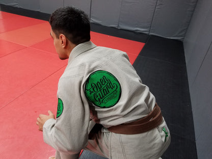 Back of the Open Guard Apparel Circle Flow Gi in Tactical Sand & Emerald. 